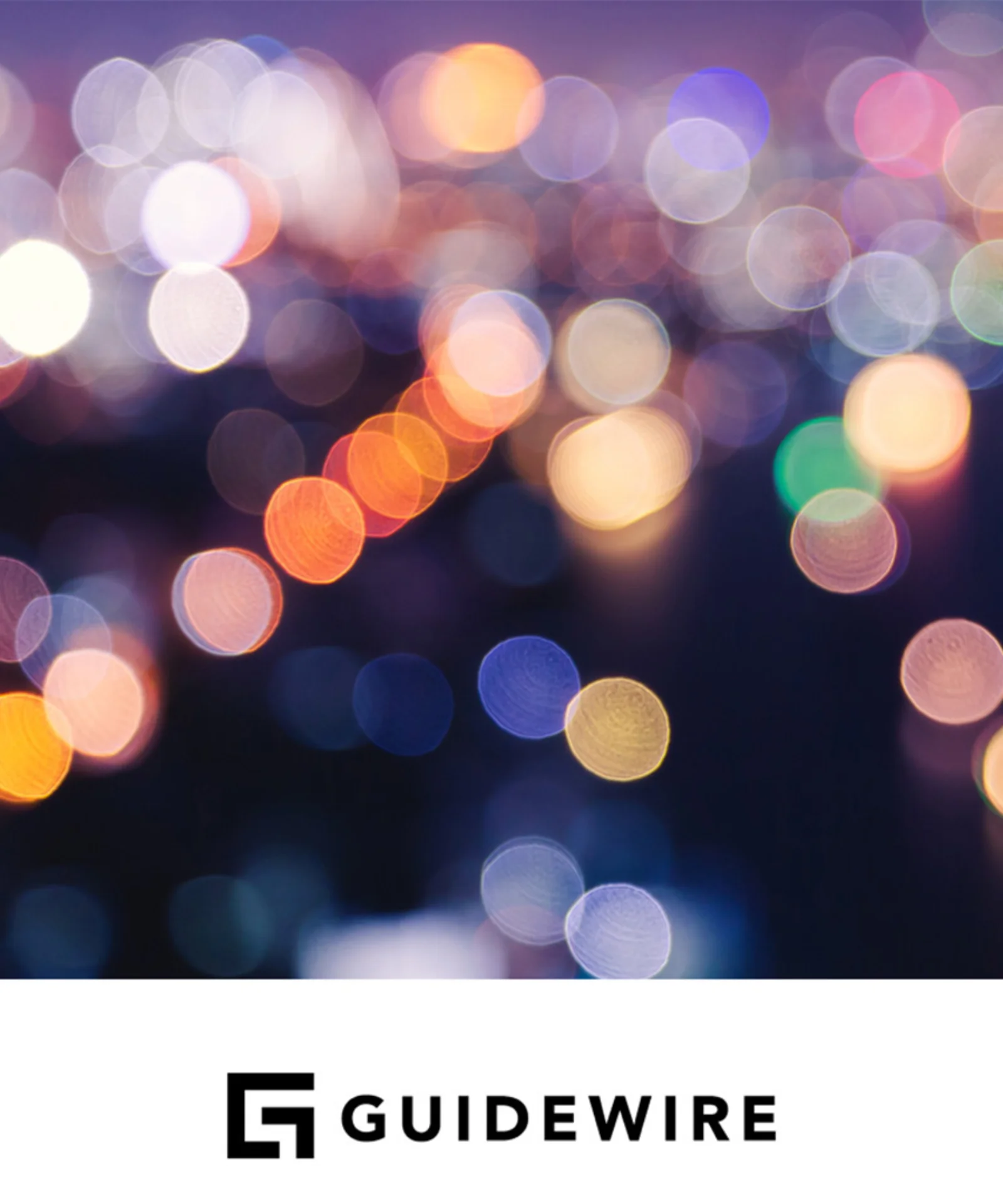 A colorful, abstract cityscape with out-of-focus lights, symbolizing the vibrant and dynamic nature of platform modernization. The Guidewire logo is prominently displayed at the bottom.