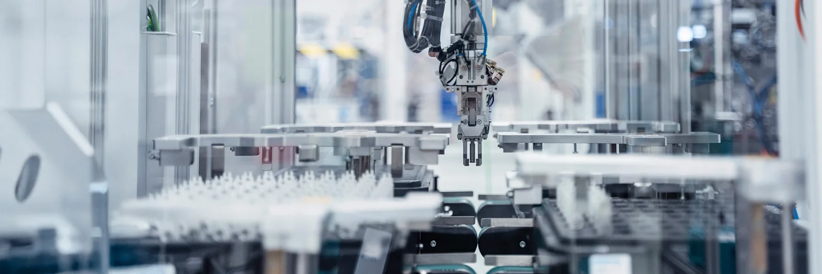 Robotic arm in an automated production line in a modern factory setting.