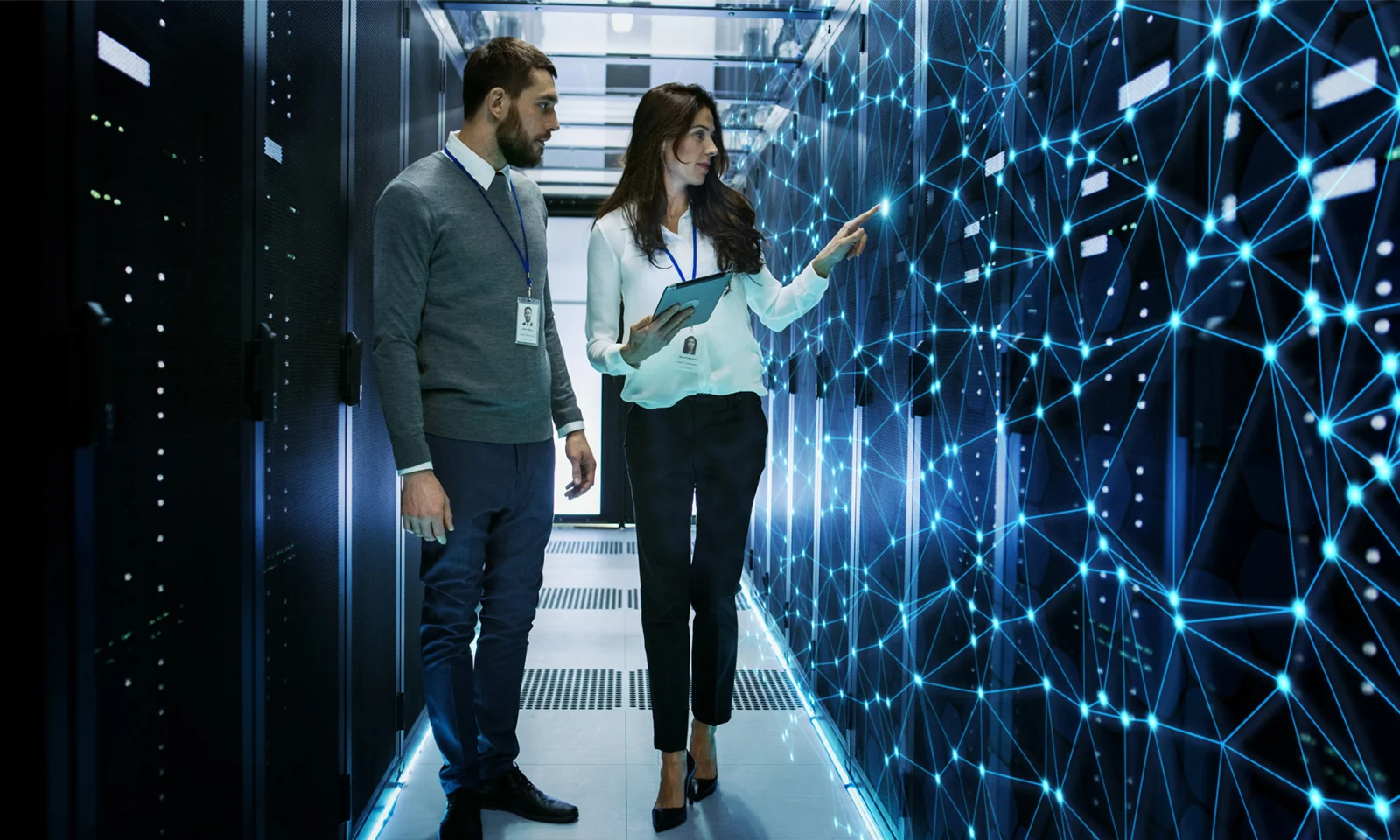 Toyota Bank Implements Visionary Sales Platform Two professionals in a data centre discussing and analysing a digital network, representing the implementation of a visionary sales platform.