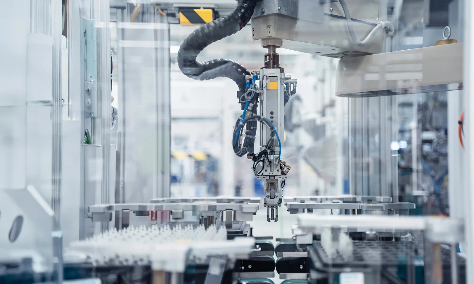 Key Visual: Manufacturing Robotic arm in an automated production line in a modern factory setting.