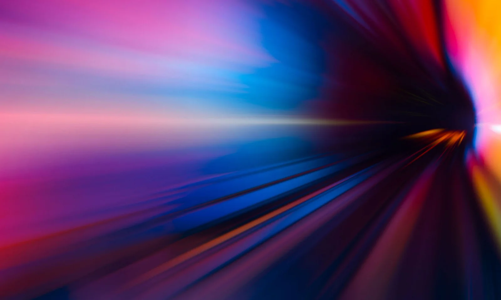 Una imagen clave vibrante que representa el impacto de la IA, con una explosión dinámica de colores que van del rosa y el morado al azul y el amarillo, sin ningún patrón superpuesto. Clave visual del impacto de la IA