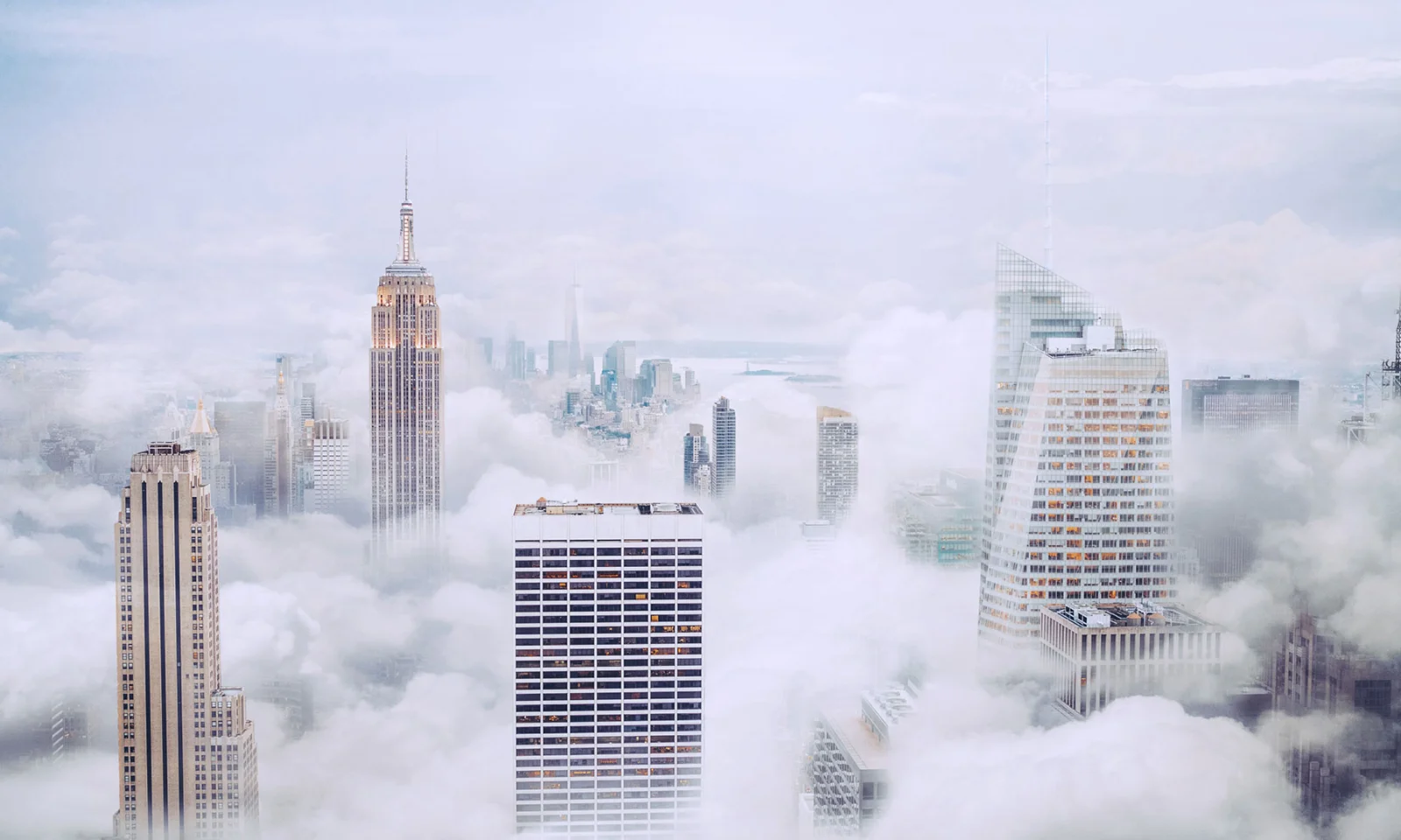 Skyline of Skyscrapers Rising Above the Clouds A breathtaking view of skyscrapers towering above the clouds in a misty cityscape, symbolising innovation and modern architecture.