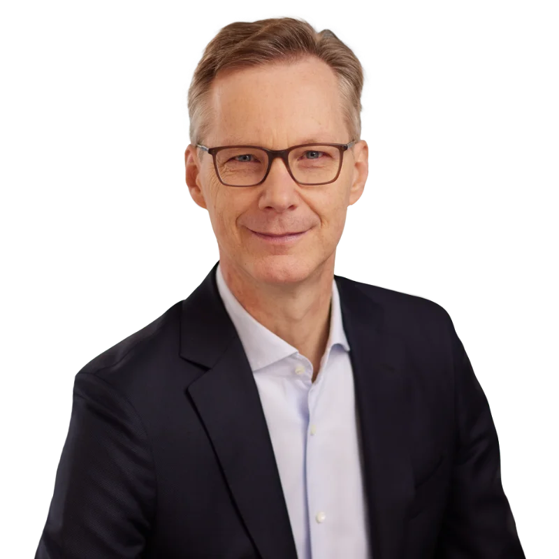 Jochen Rütz Portrait of Jochen Rütz in a black blazer and glasses.